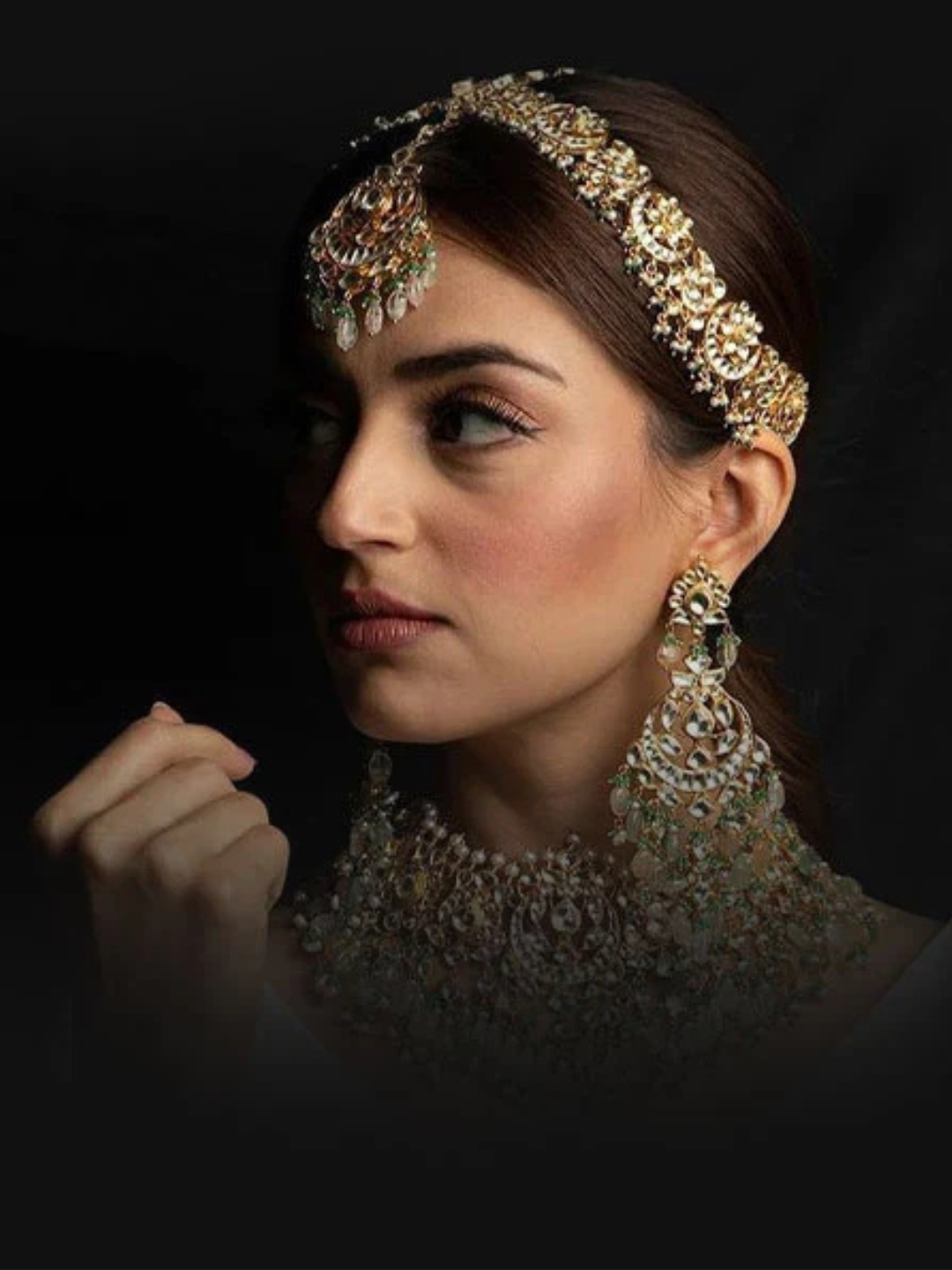 Bridal kundan jewellery with statement earrings and a traditional matha patti